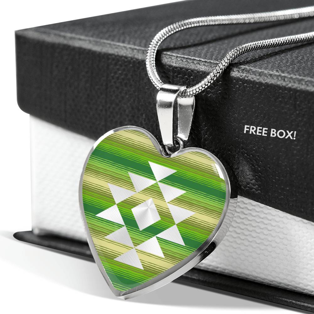 Heart Shaped Pendant With Tribal Element on Green and Tan Serape Style Background
