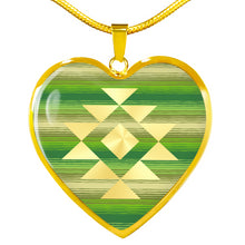 Load image into Gallery viewer, Heart Shaped Pendant With Tribal Element on Green and Tan Serape Style Background
